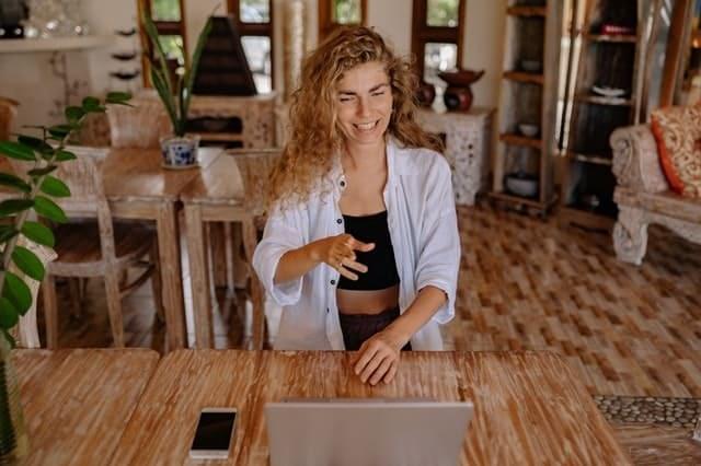 A woman is watching a webinar in her laptop